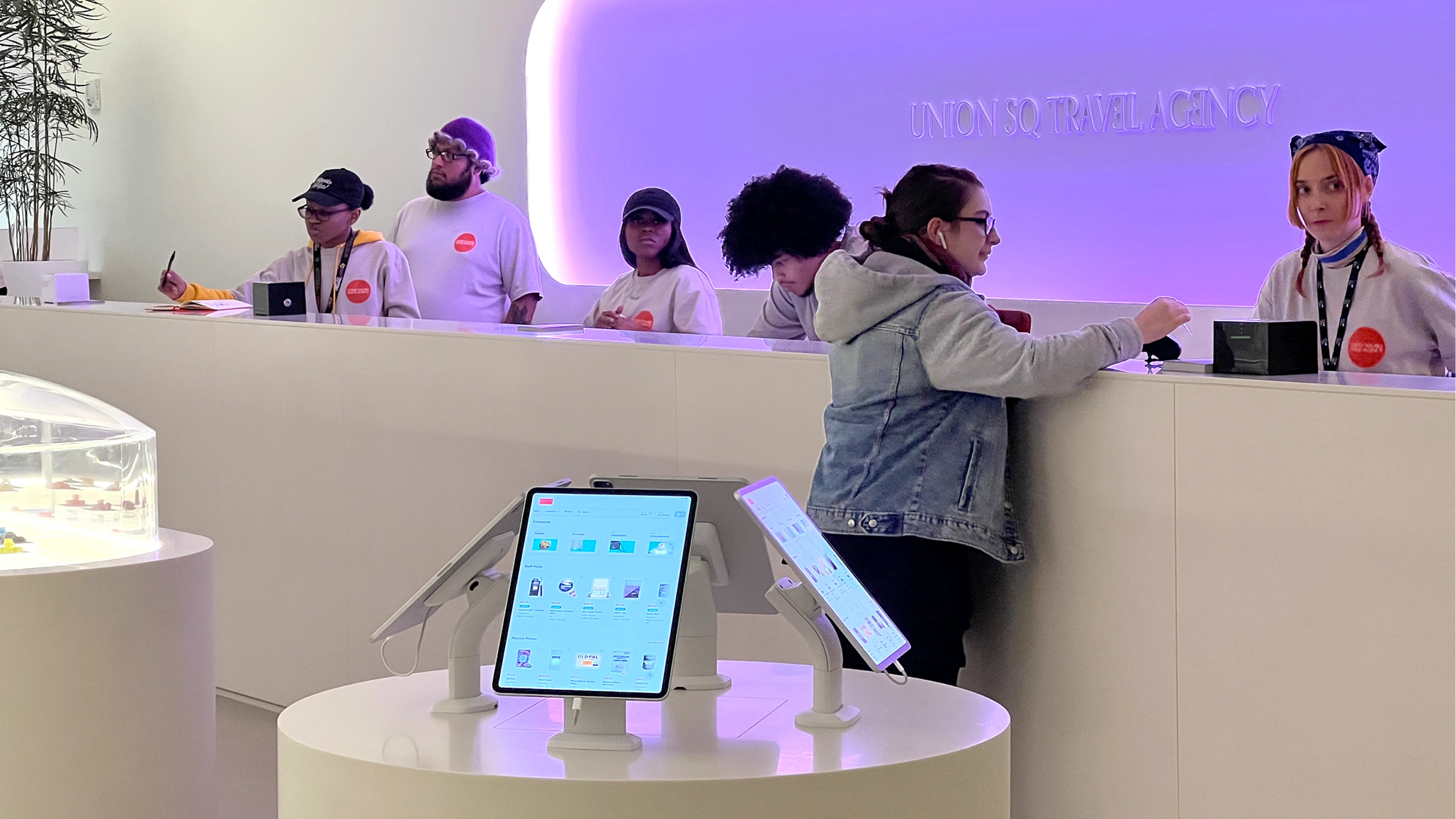 Customers of The Travel Agency, paying for cannabis at register.