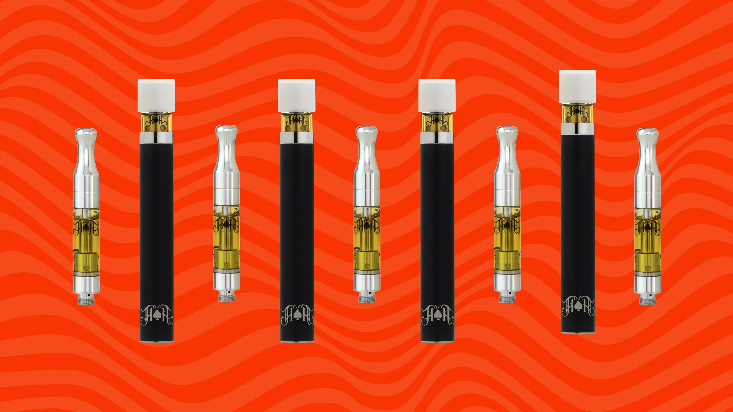 Heavy Hitters vapes left to right with red background.