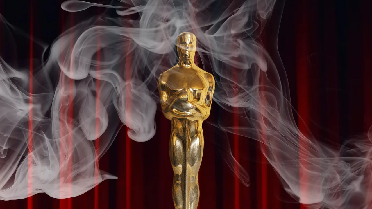 Oscar award behind a smokey haze.
