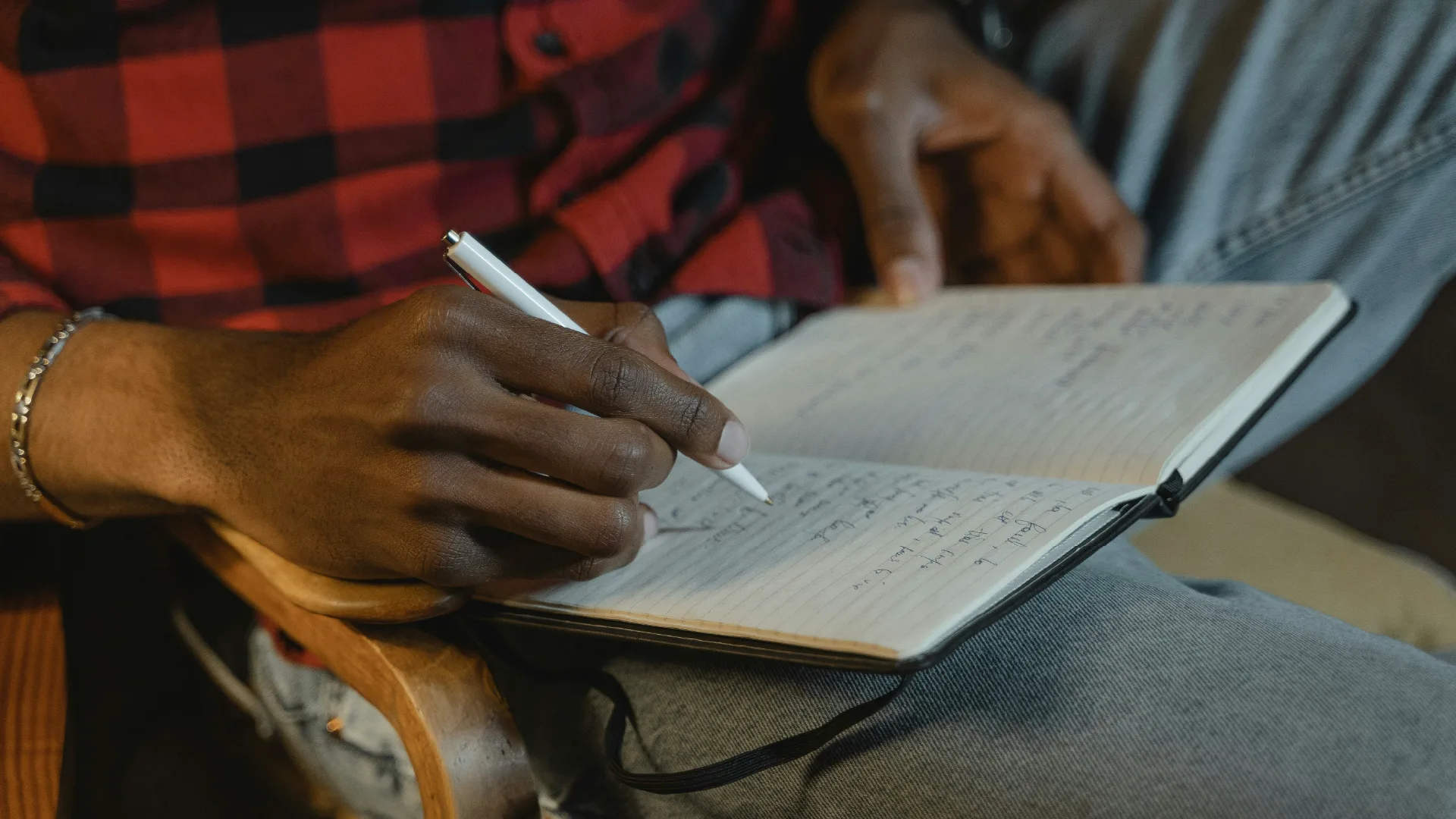 Man writing in his cannabis journal.