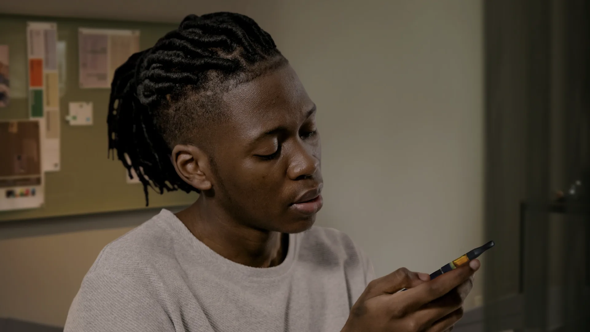 Man staring at his malfunctioning vape pen.