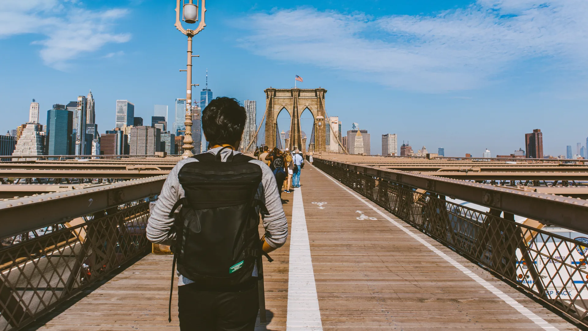 Man walking on NYC bridge.